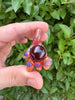 Early Hand holding Orb Pendant